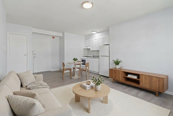 Chic open-plan living area with cozy beige sofa, elegant dining set, and modern kitchen. Natural light enhances the minimalist decor and sleek wooden furniture.