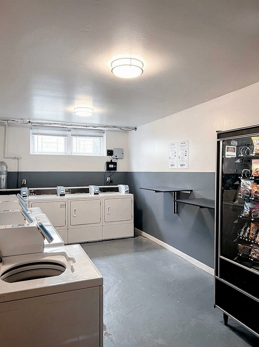 Bright, modern laundry room with efficient washers, dryers, and a convenient snack vending machine.