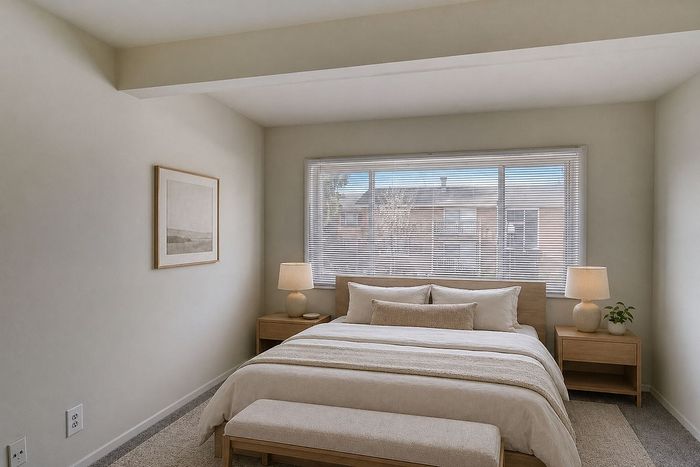 Elegant bedroom with a cozy king-sized bed, warm natural light, stylish decor, and soft neutral tones.