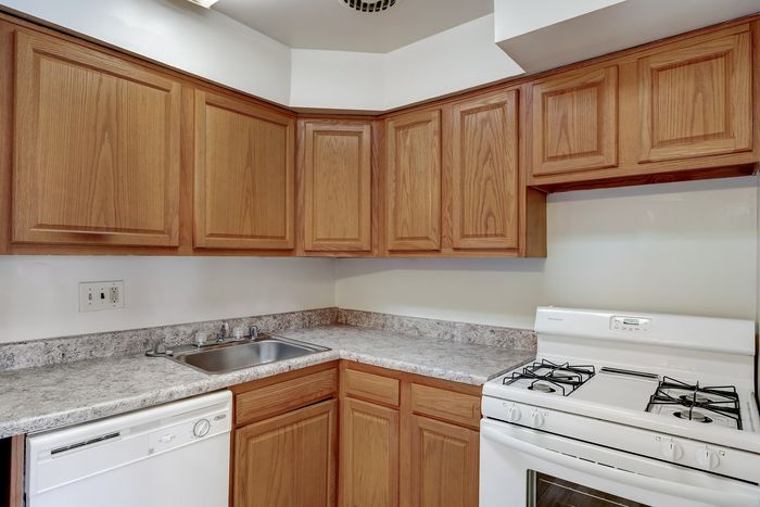 Cozy kitchen with elegant wooden cabinets, sleek countertops, and modern appliances including a gas stove and dishwasher.