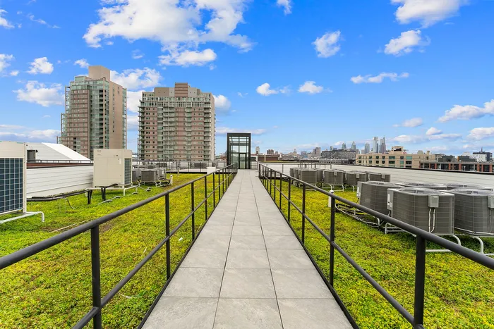 Modern rooftop oasis with lush green space and stunning city skyline views, featuring an elegant pathway and contemporary architecture.