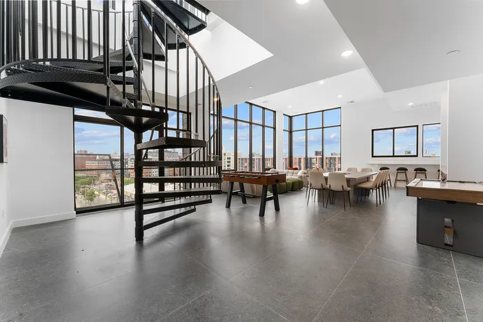 Modern apartment interior with sleek spiral staircase, large windows with city views, stylish lounge area, and dining space.