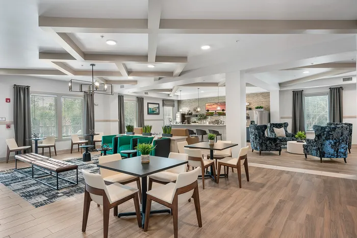 Elegant open-concept lounge with modern furnishings, sleek hardwood floors, and abundant natural light.