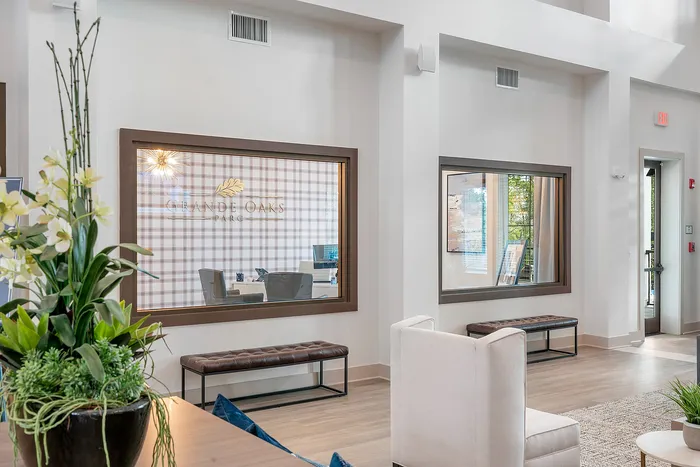 Inviting modern lobby with chic decor and ample natural light at Grande Oaks Parc.
