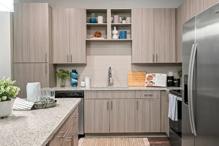 Modern kitchen design with sleek gray cabinetry, stainless steel appliances, and stylish granite countertops.