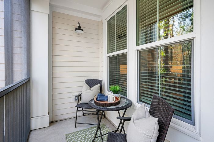Charming outdoor patio with cozy seating, stylish decor, and abundant natural light.