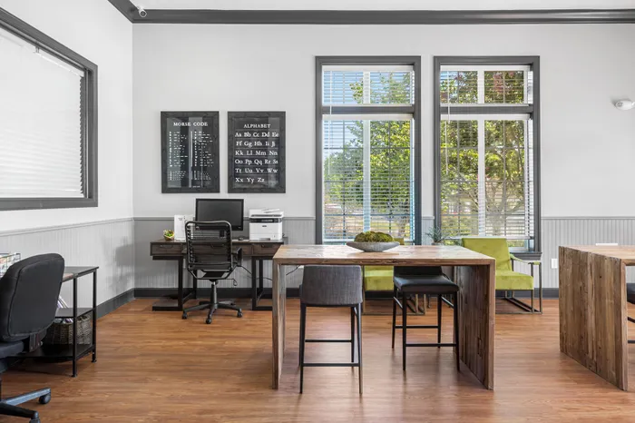 Bright and inviting home office space with modern wooden furniture, large windows, and stylish decor. Ideal for productivity.