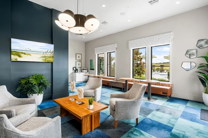 Modern and inviting lounge space with stylish seating, vibrant wall art, large windows, and contemporary lighting, perfect for relaxation and entertainment.