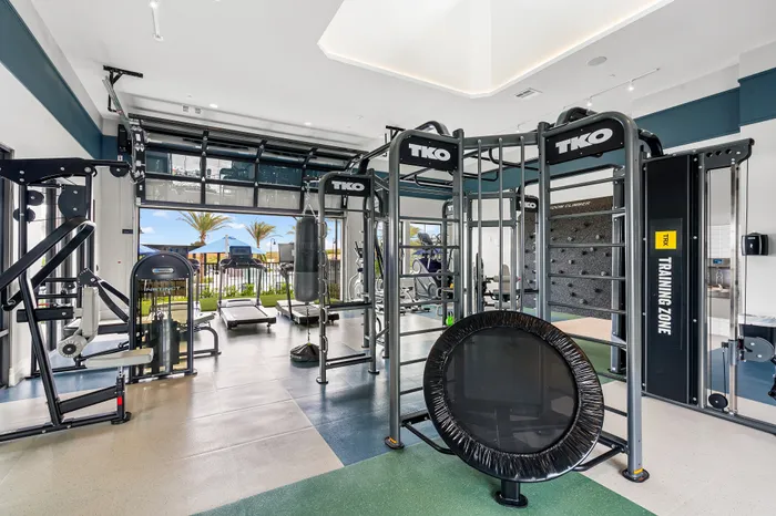 Modern fitness center featuring top-of-the-line workout equipment, open space with natural light, and vibrant outdoor views.