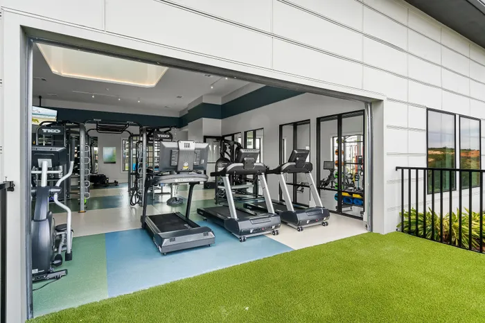 Modern fitness center featuring state-of-the-art treadmills and exercise equipment, with large windows offering serene views.