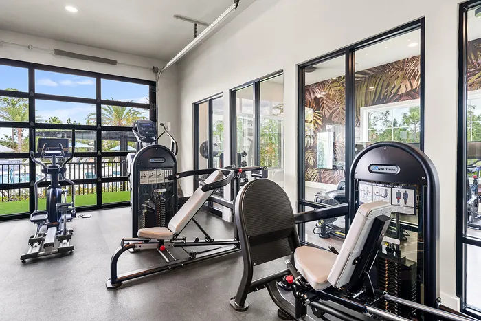 Bright and modern fitness center with state-of-the-art equipment and panoramic windows offering serene views.