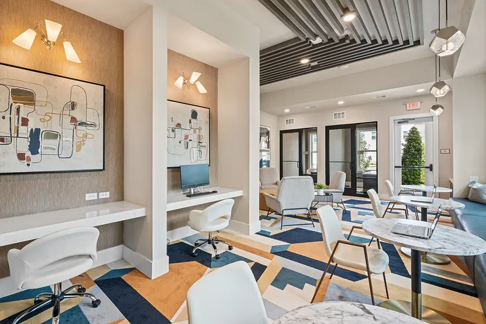 Elegant co-working space with modern decor, abstract art, and stylish seating areas for collaboration.