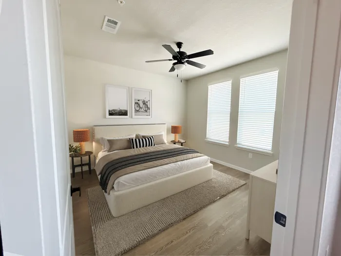 Inviting bedroom with soft natural light, stylish decor, and a plush bed, creating a serene retreat.