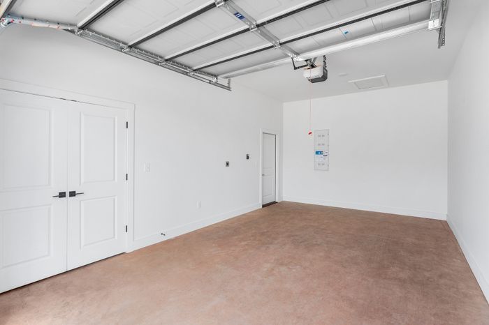 Spacious and bright garage with a sleek white finish, perfect for storage or a workshop.