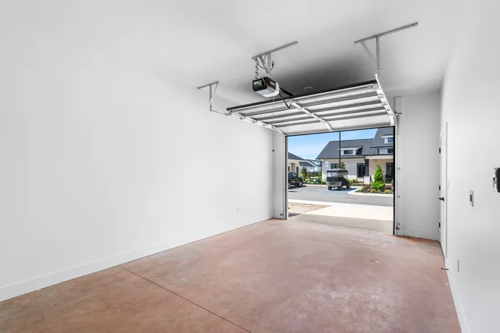 Spacious and bright single-car garage with a sleek modern design, offering direct access to a charming residential neighborhood.