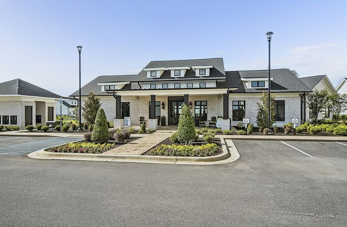 Charming modern building surrounded by lush landscaping, showcasing elegant architecture and inviting pathways.