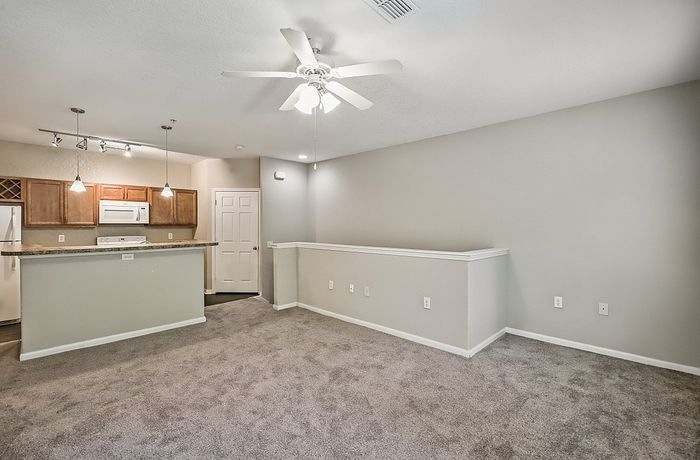 Inviting open-plan living area with stylish kitchen, elegant lighting, and modern finishes.