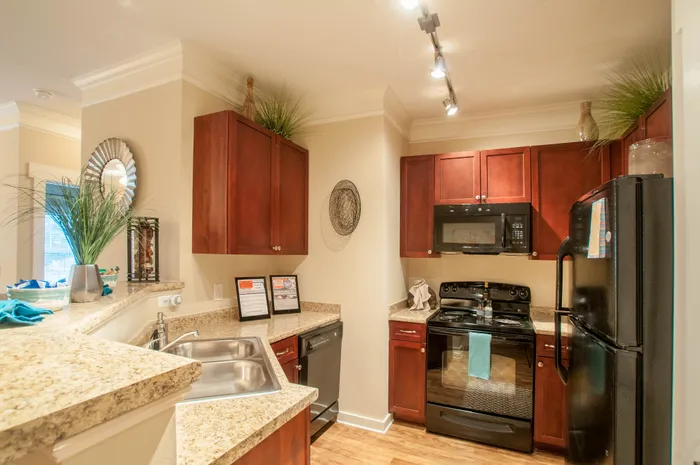 Elegant kitchen with rich wood cabinets, granite countertops, and modern appliances, creating a warm and inviting space.