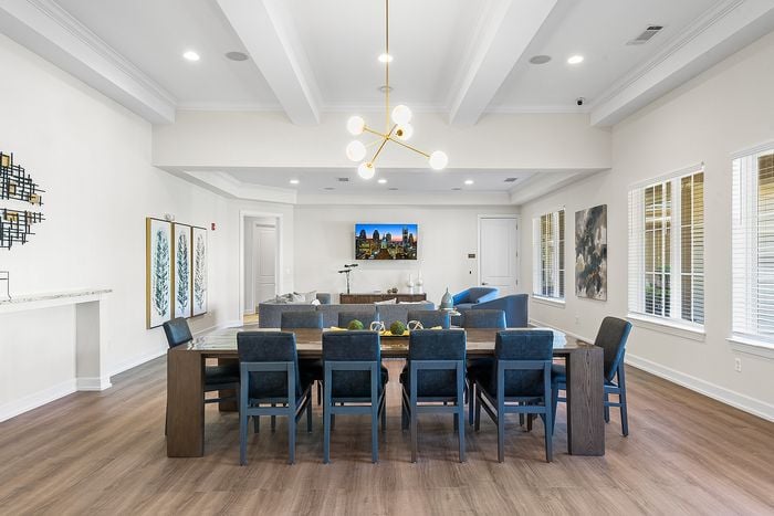 Elegant open-concept dining and living room featuring stylish lighting, modern decor, and abundant natural light.