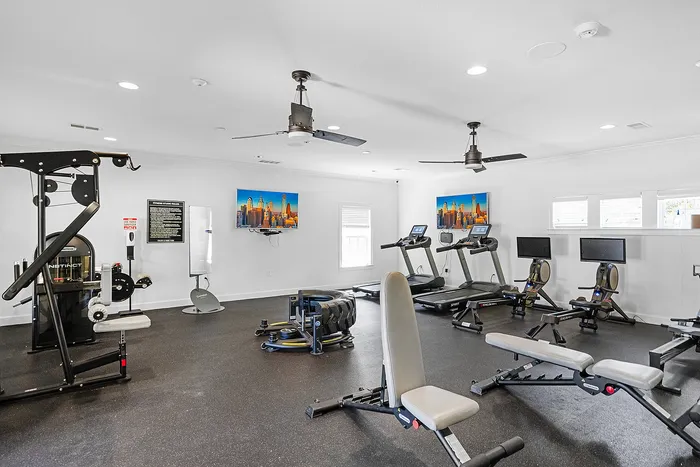 Modern fitness center with state-of-the-art equipment, including treadmills, weight machines, and sleek decor for a premium workout experience.
