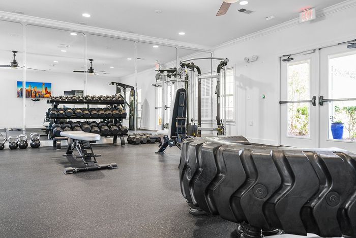 Modern fitness center featuring state-of-the-art equipment, vibrant decor, and natural light for an invigorating workout experience.