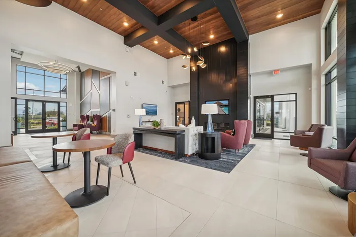 Modern, inviting lobby showcasing sleek furniture, high ceilings, and abundant natural light.