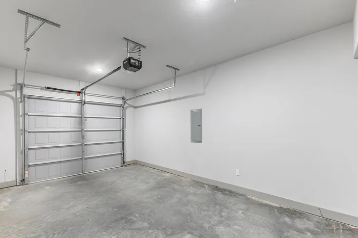 Spacious modern garage with a sleek automatic door, perfect for secure parking and storage.