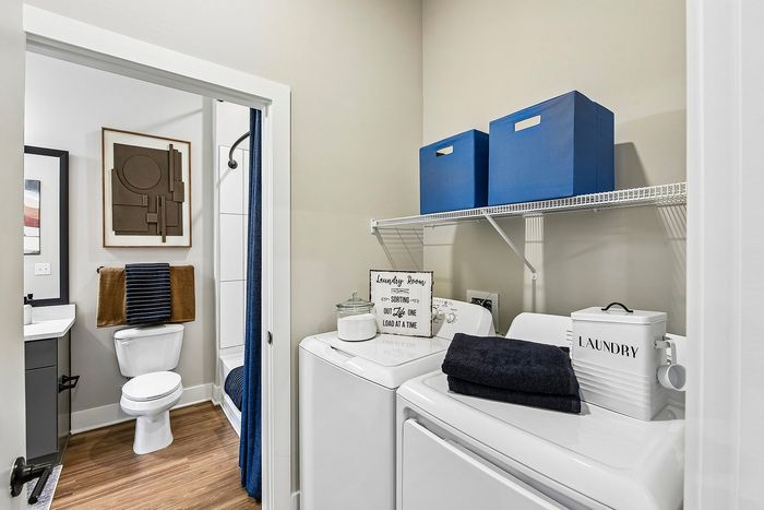 Chic laundry room with modern washer and dryer, elegant storage solutions, and stylish decor accents.