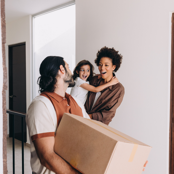 Joyful family moving into a bright, modern apartment with excitement and a sense of new beginnings.