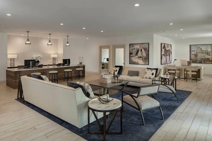 Luxurious open-concept living space featuring contemporary seating, elegant artwork, and a stylish work area with modern lighting.