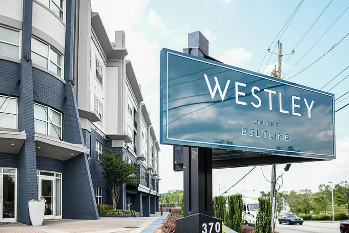 Modern apartment complex exterior with elegant brick facade and prominent 'Westley on the Beltline' sign, showcasing urban living.