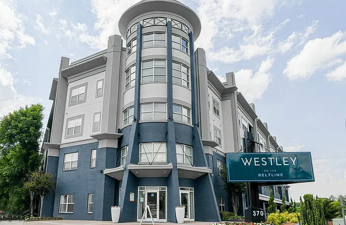 Modern apartment building with striking architecture and lush surroundings at Westley on the Beltline.