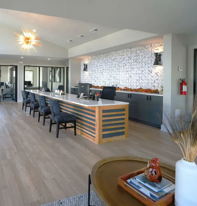 Contemporary lobby featuring elegant lighting, modern seating, and a textured wall design, perfect for a welcoming atmosphere.