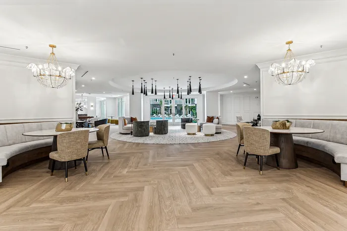 Elegant communal lounge featuring chic chandeliers, modern seating, and stylish decor, highlighting luxurious living.