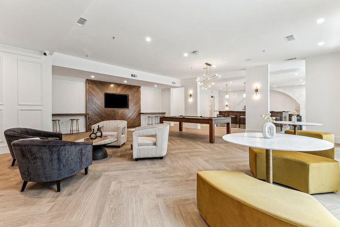 Luxurious entertainment lounge with chic seating, billiards table, and elegant decor for social gatherings.
