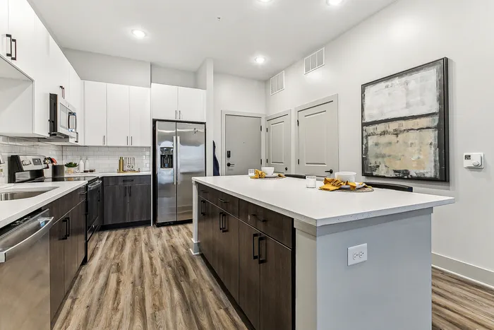 Modern kitchen with sleek cabinetry, stainless steel appliances, and a spacious island with elegant countertops.