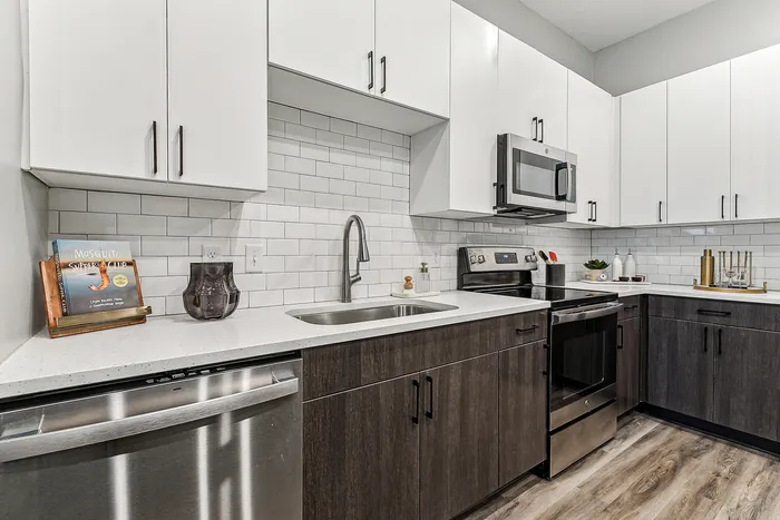 Modern kitchen featuring sleek stainless steel appliances, elegant white cabinetry, and a chic subway tile backsplash.