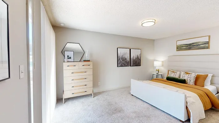 Bright and modern bedroom featuring a cozy bed with plush pillows, stylish dresser, and elegant wall art for a serene atmosphere.