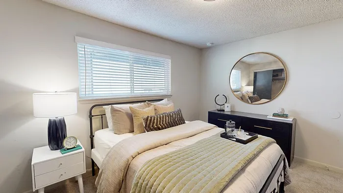 Inviting bedroom with plush bedding, elegant decor, and ambient lighting creating a cozy retreat.