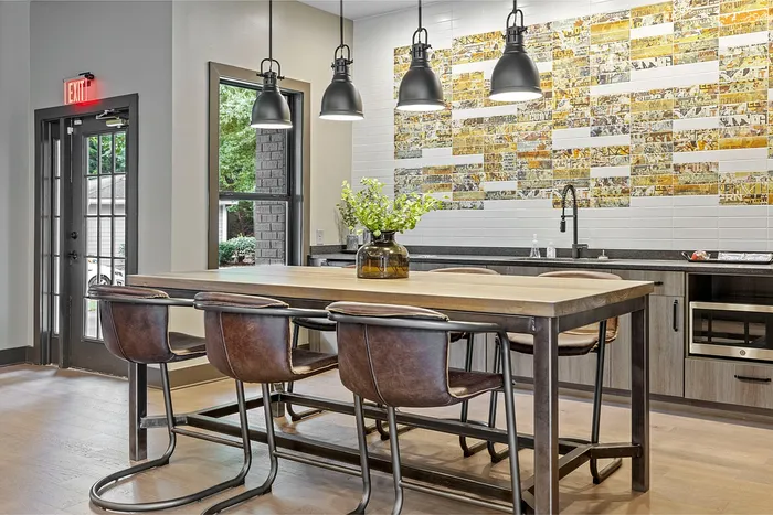 Chic and inviting lounge area with modern seating, rustic wood accent wall, and vibrant artwork.