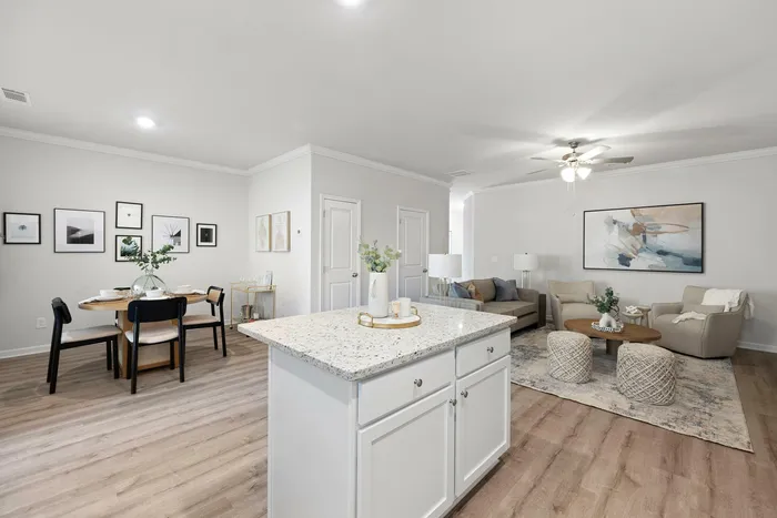 Chic open-concept living area with a modern kitchen island, elegant dining set, and stylish living room arrangement.