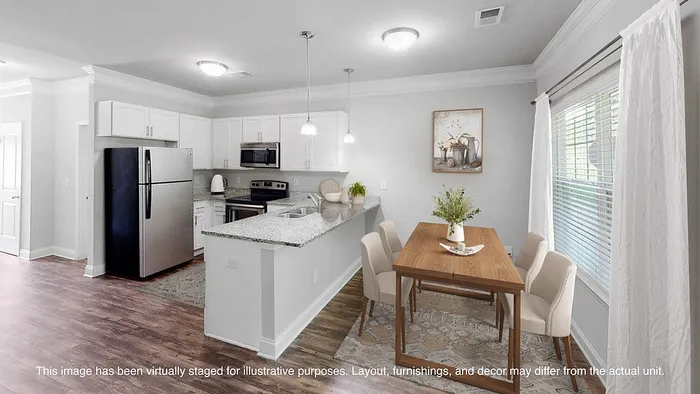Modern open-concept kitchen and dining area with sleek appliances, granite countertops, and elegant natural light.