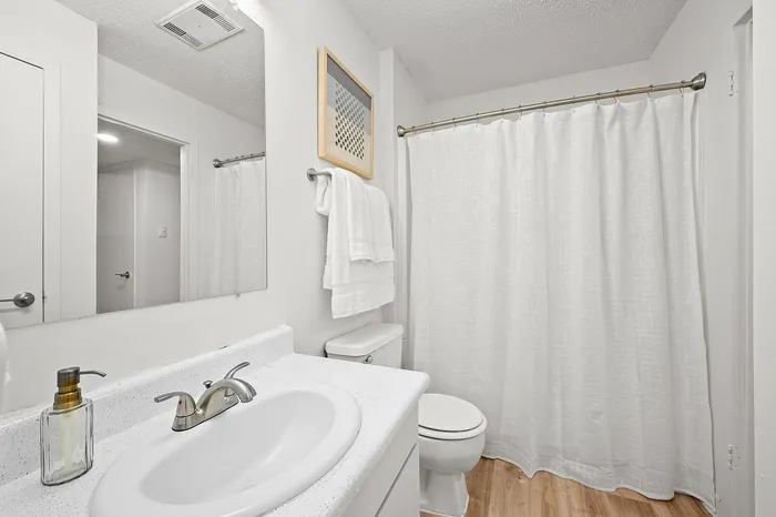 Elegant bathroom with sleek fixtures, modern sink, and soft lighting, providing a tranquil retreat.