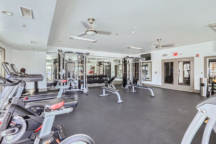 Modern fitness center featuring state-of-the-art gym equipment and a spacious workout area.