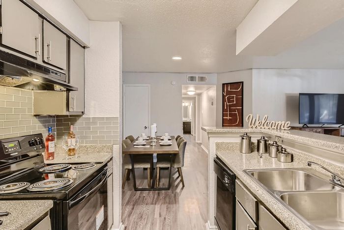 Inviting modern kitchen with sleek appliances, stylish dining area, and elegant decor for a cozy living experience.