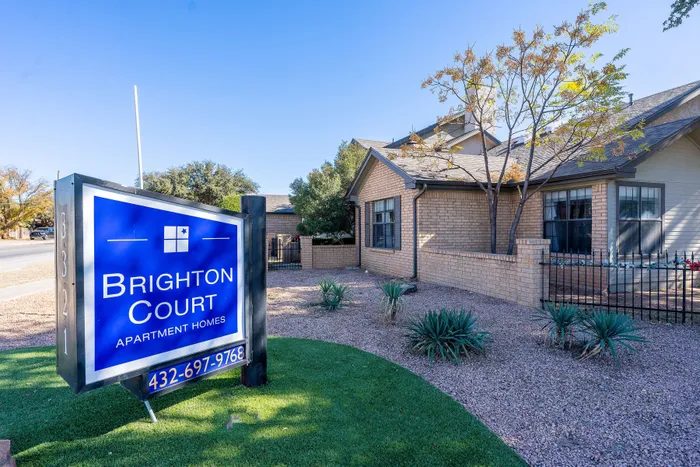 Charming Brighton Court apartment homes with welcoming entrance, manicured landscaping, and inviting community ambiance.