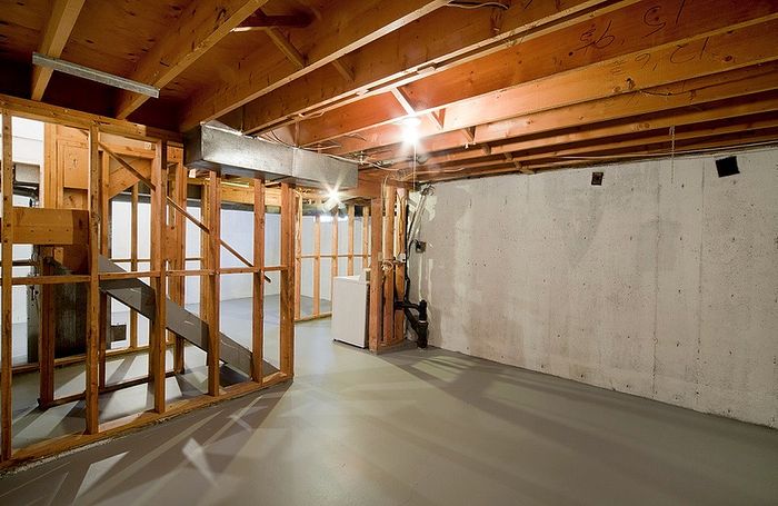 Spacious unfinished basement with sturdy wooden beams, offering potential for customization and added living space opportunities.