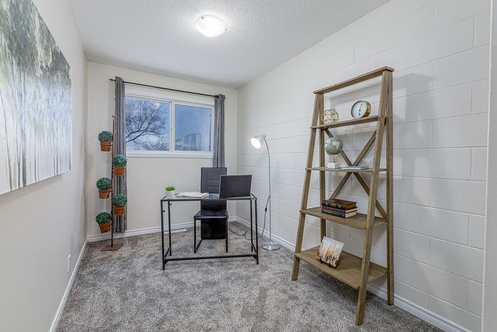 Bright and inviting home office with modern decor, featuring a sleek desk, stylish shelving, and a window view for natural light.