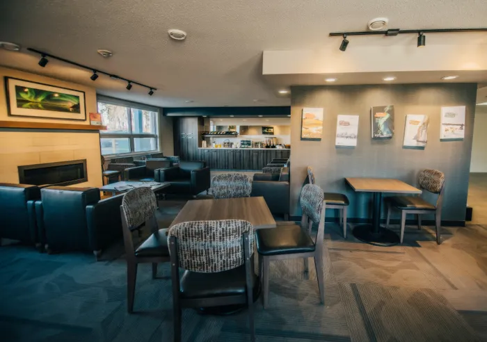 Contemporary lounge area with cozy seating, stylish fireplace, and elegant decor, perfect for relaxation and socializing.