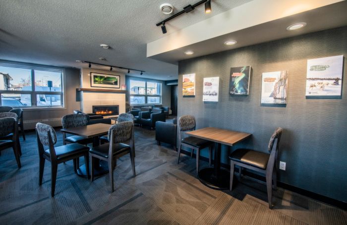 Modern and inviting lounge area with cozy seating, stylish decor, and a warm fireplace, perfect for relaxation and gatherings.